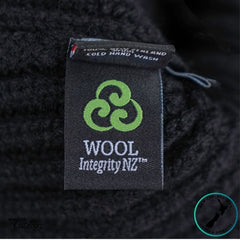 Wool Integrity NZ label on a black fabric background