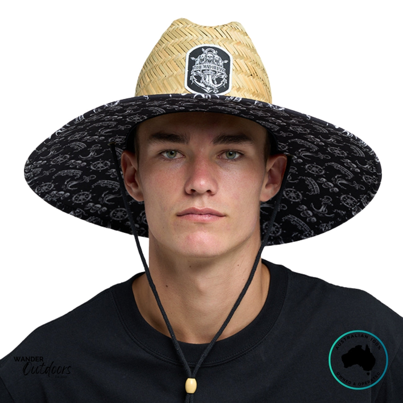 Front view of The Mad Hueys Triple Anchor Straw Hat with wide brim, black printed underbrim, and front woven patch logo.
