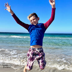 Boys being boys at the beach, having fun in their surfs up rashie