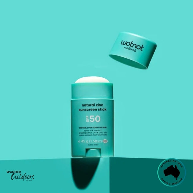 Wotnot Naturals SPF 50 Zinc Sunscreen Stick with cap hovering above, showing stick partially extended.