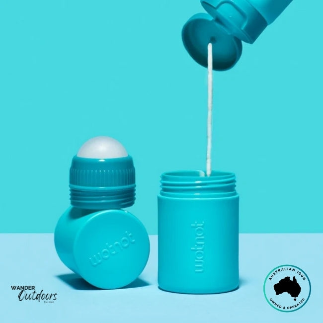 Close-up of Wotnot Refillable Sunscreen Roll-On being refilled with sunscreen from an open bottle.